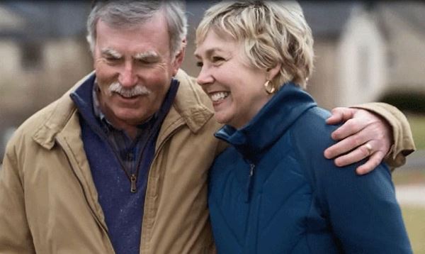 Gail Hogan and her husband walk outdoors Gail Hogan and her husband walk outdoors